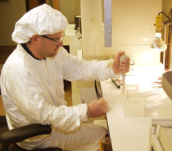 Technologist loading samples for thermal ionization mass spectrometry.