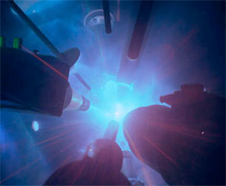 Internal view of the University of Rochester OMEGA Laser's target chamber during a target shot